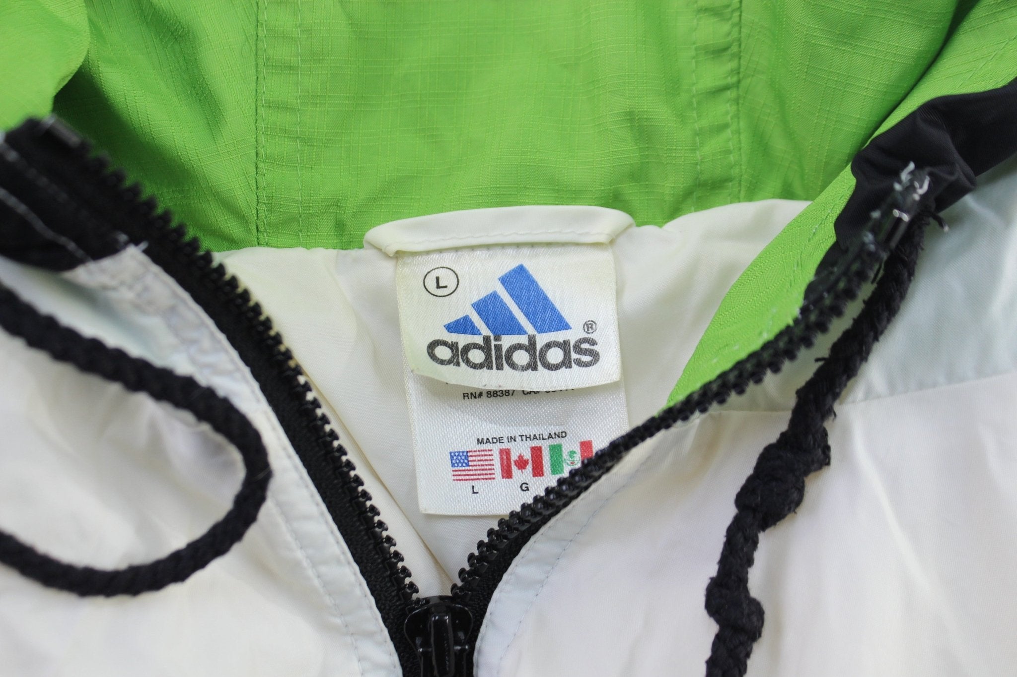 Vintage Adidas Embroidered Logo Black, Green, & White Pullover Jacket - ThriftedThreads.com