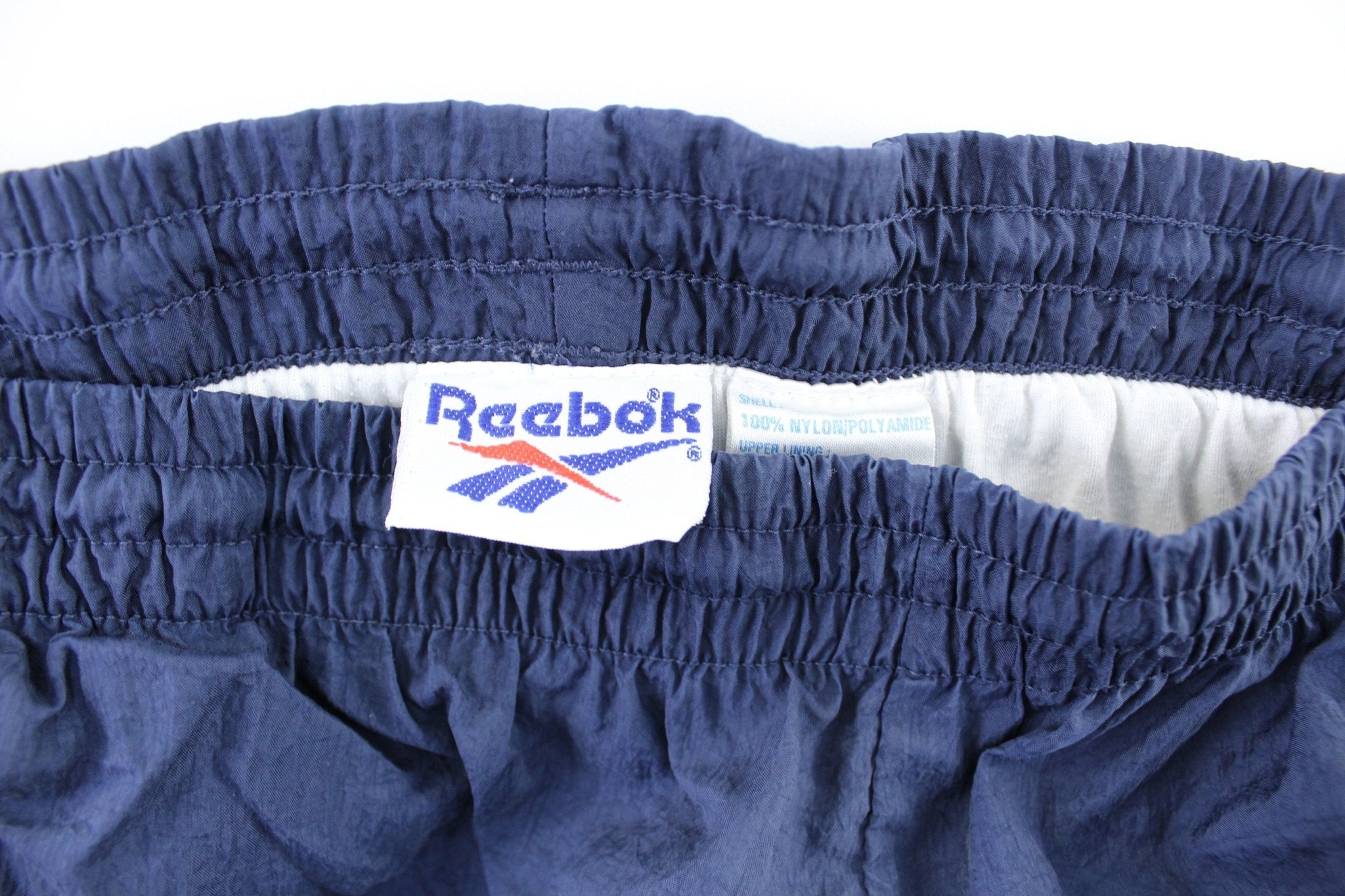 Vintage Reebok Embroidered Logo Navy Blue Windbreaker Pants - ThriftedThreads.com