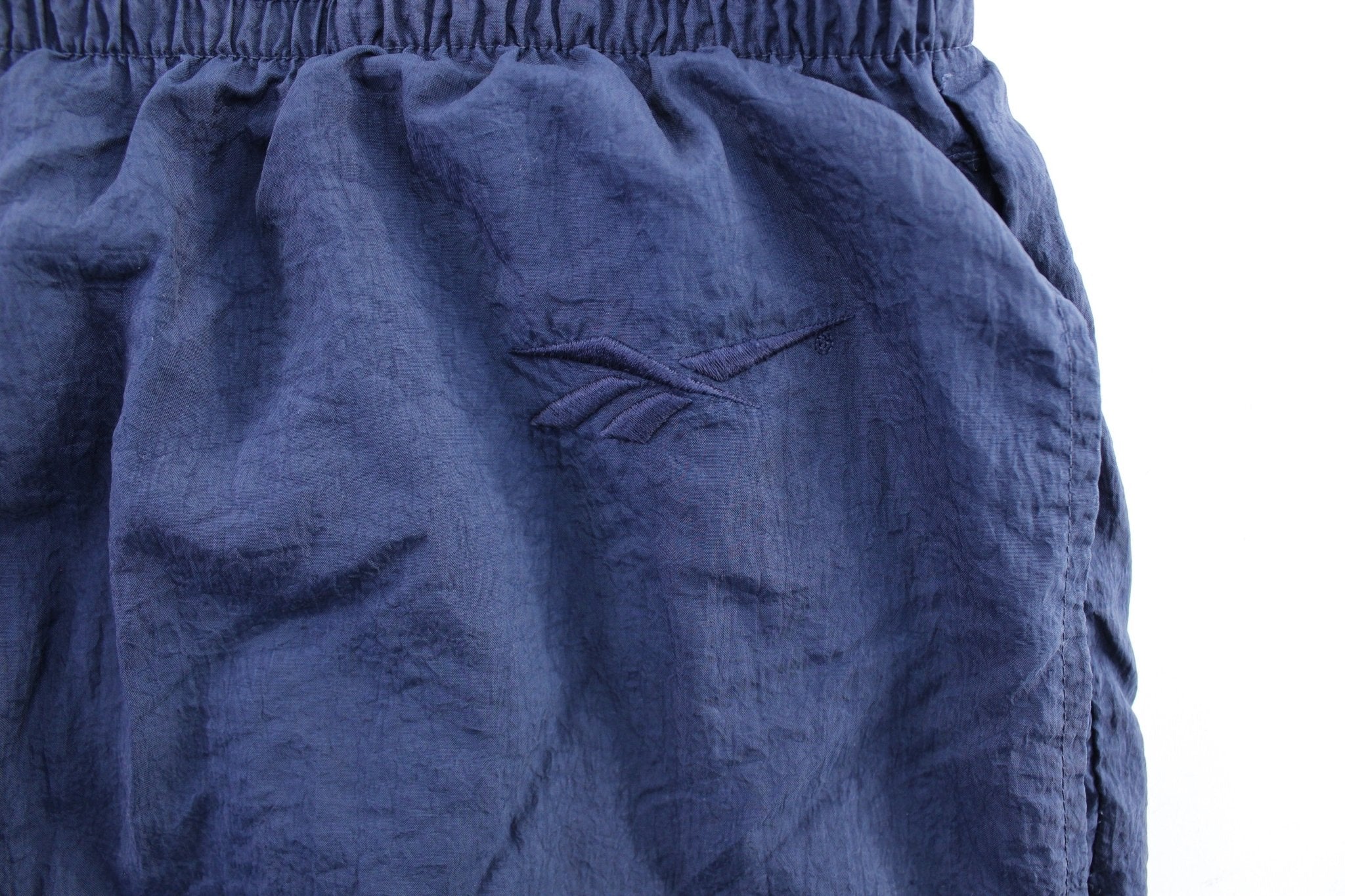 Vintage Reebok Embroidered Logo Navy Blue Windbreaker Pants - ThriftedThreads.com